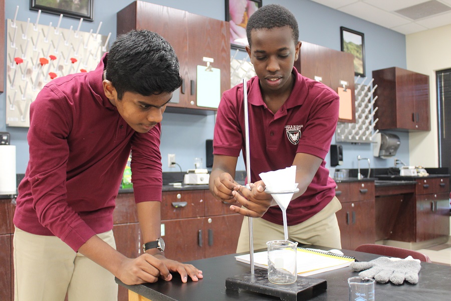 Two students work on a science experiment